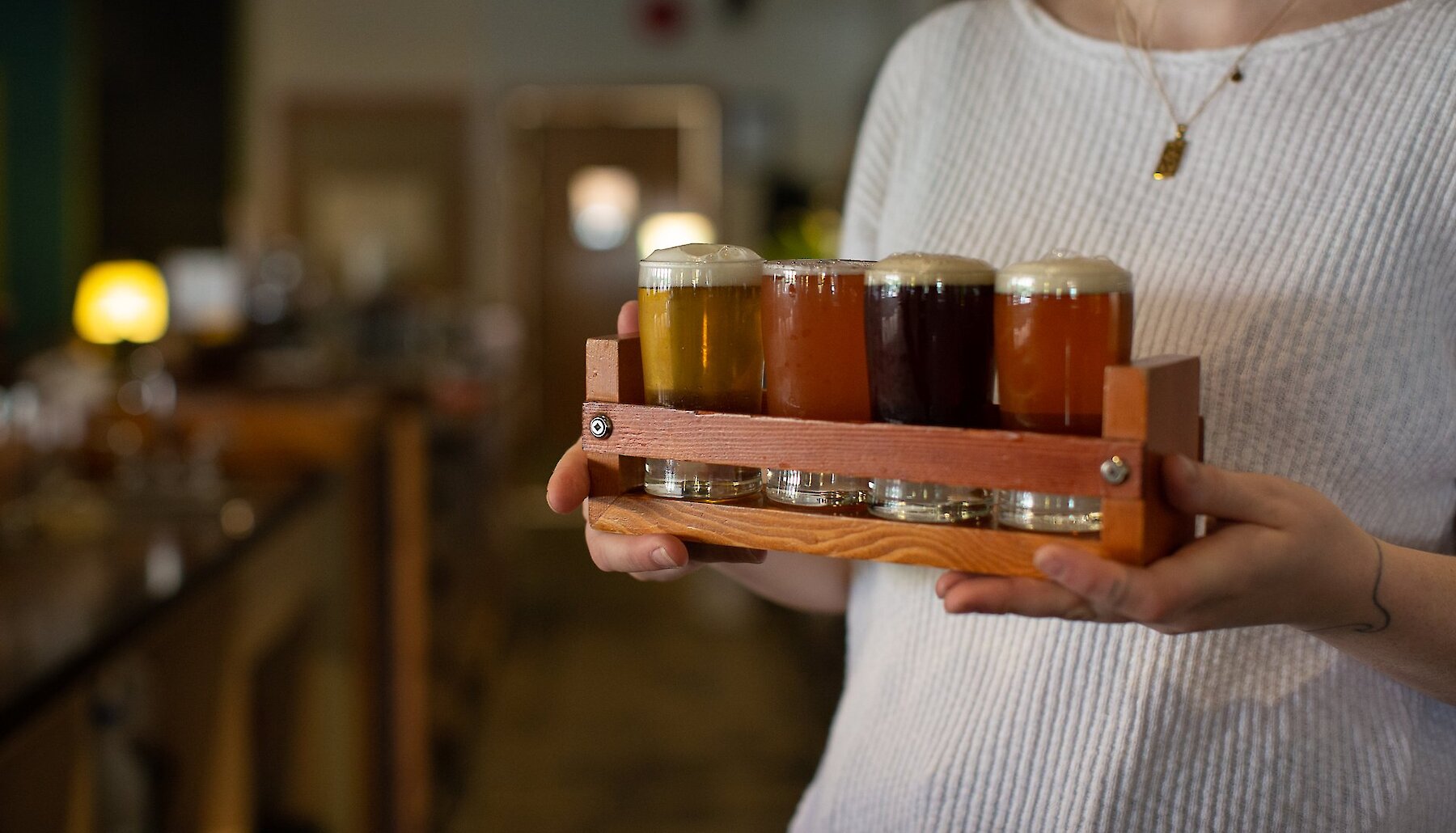 A server delivers a flight of craft beer samplers at one of Kamloops' craft breweries.