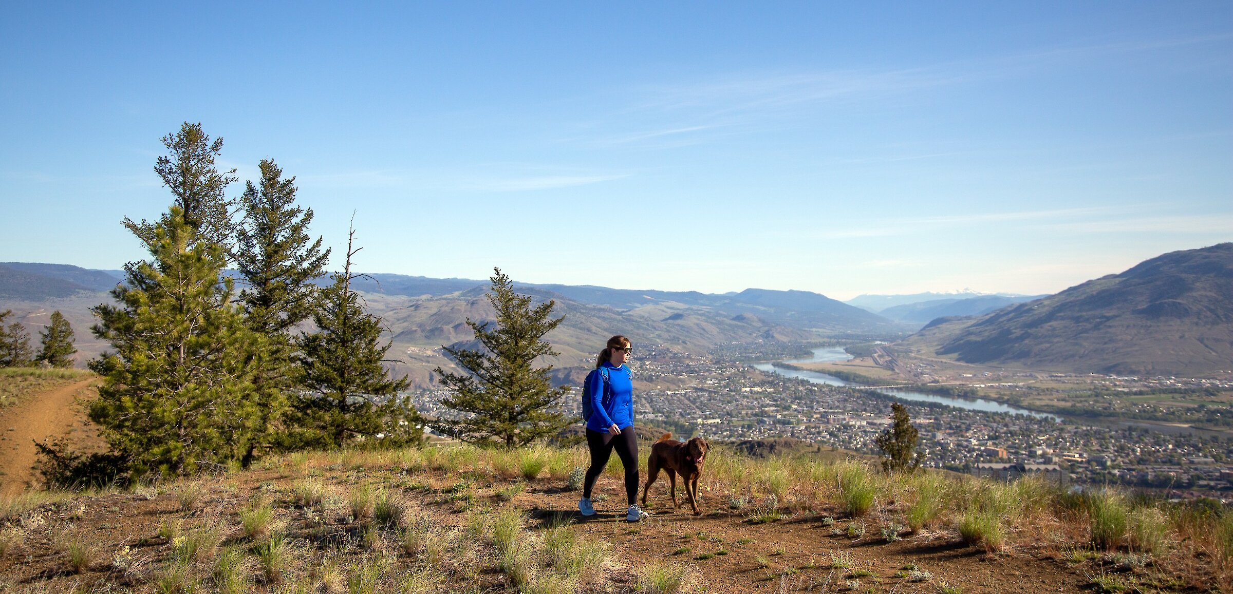 Woman walking her dog on the trails at Kenna Cartwright Nature Park
