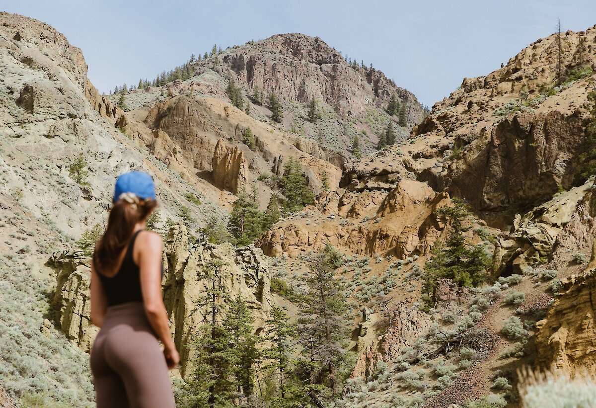 A hiker admiring the Cinnamon Ridge Hoodoos in Kamloops, BC.