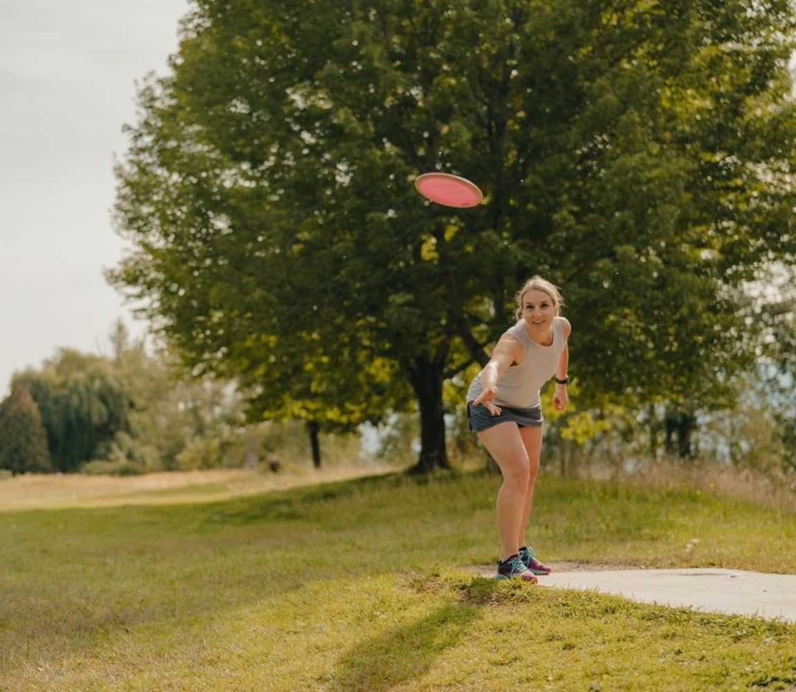 Woman disc golfing at McArthur Island