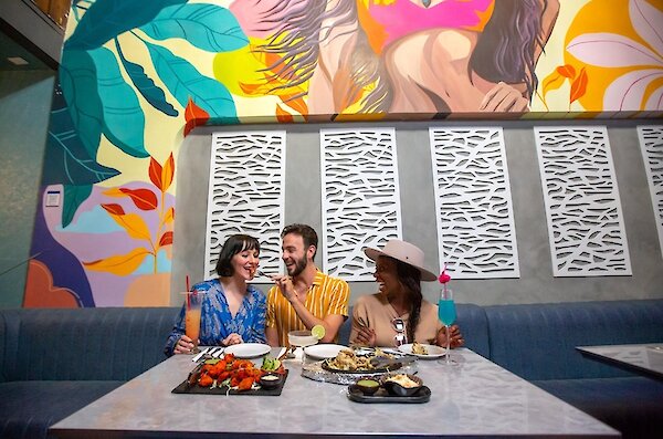 A group of friends eating their entrees at Maaza Indian Kitchen + Bar located in downtown Kamloops, British Columbia.