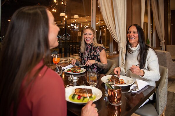 A group of friends eating their entrees at La Condesa located in downtown Kamloops, British Columbia.
