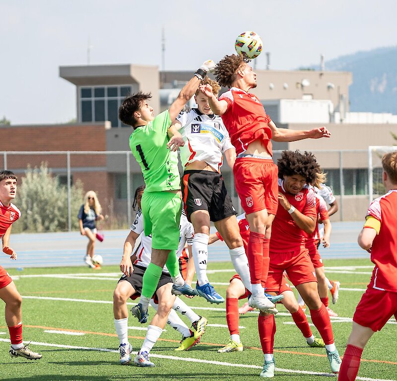 Player heads the soccer ball during the Kamloops International Cup.
