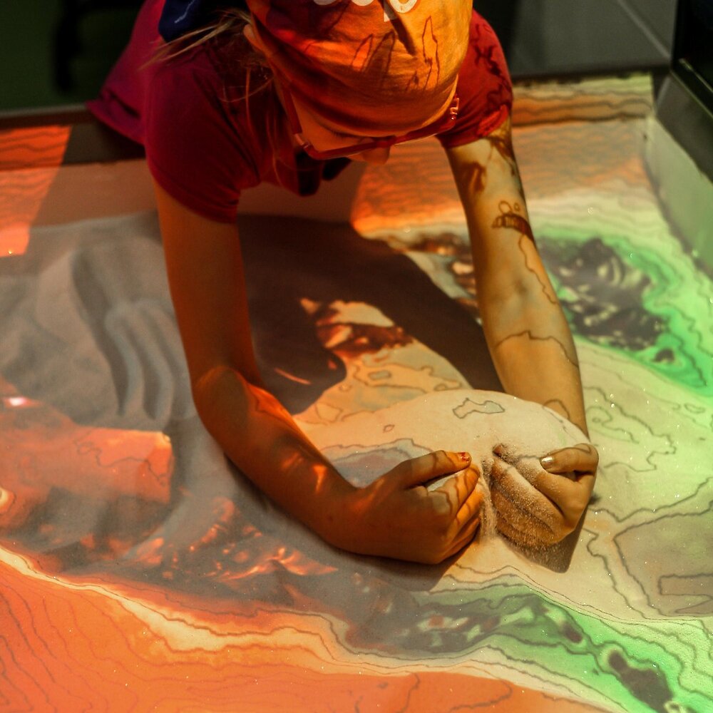 Boy playing with the topographical interactive exhibit at the Big Little Science Centre
