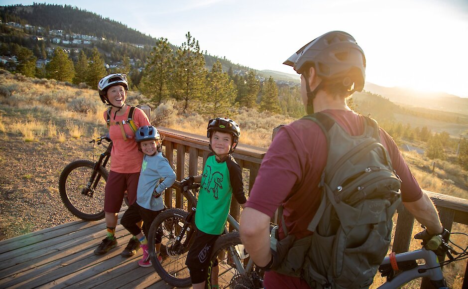Family laughing while taking a break from mountain biking at the Kamloops Bike Ranch in British Columbia.