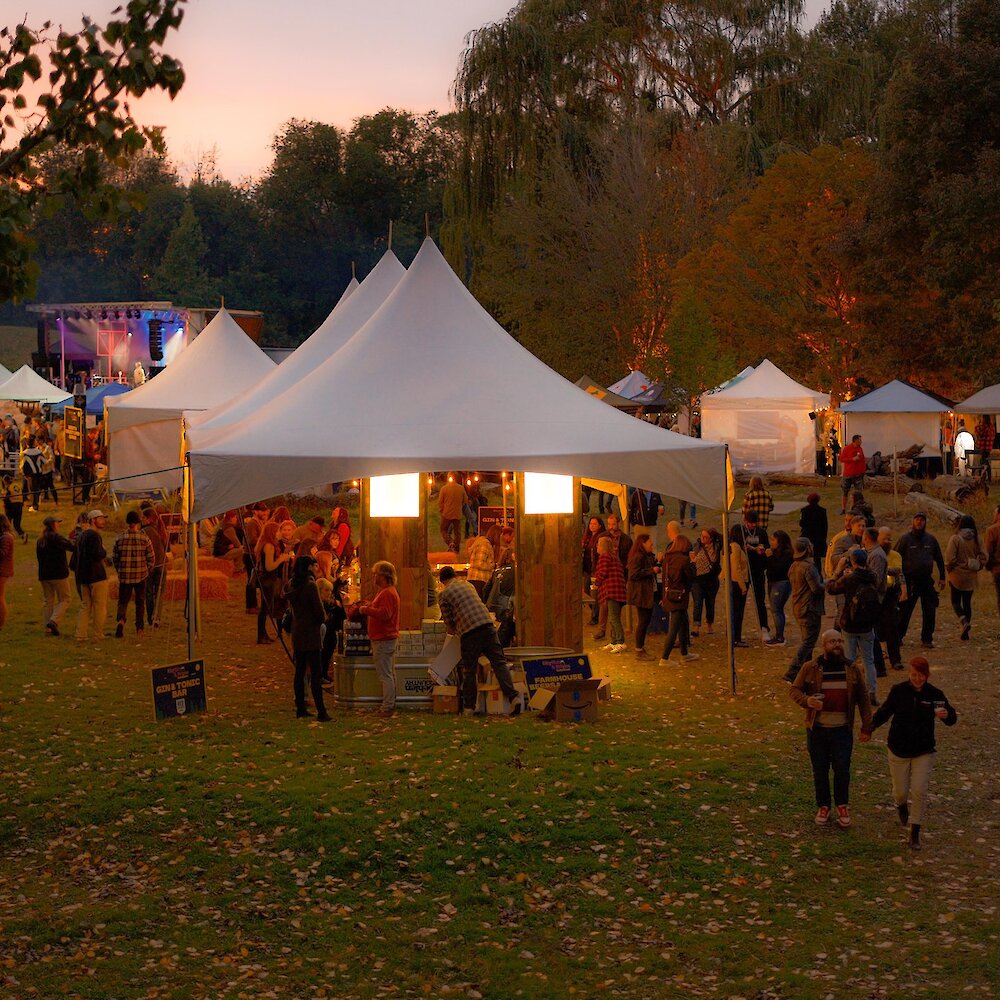 Brewloops festival tents with one of the performance stages in the background at McArthur Island Park in Kamloops, BC.