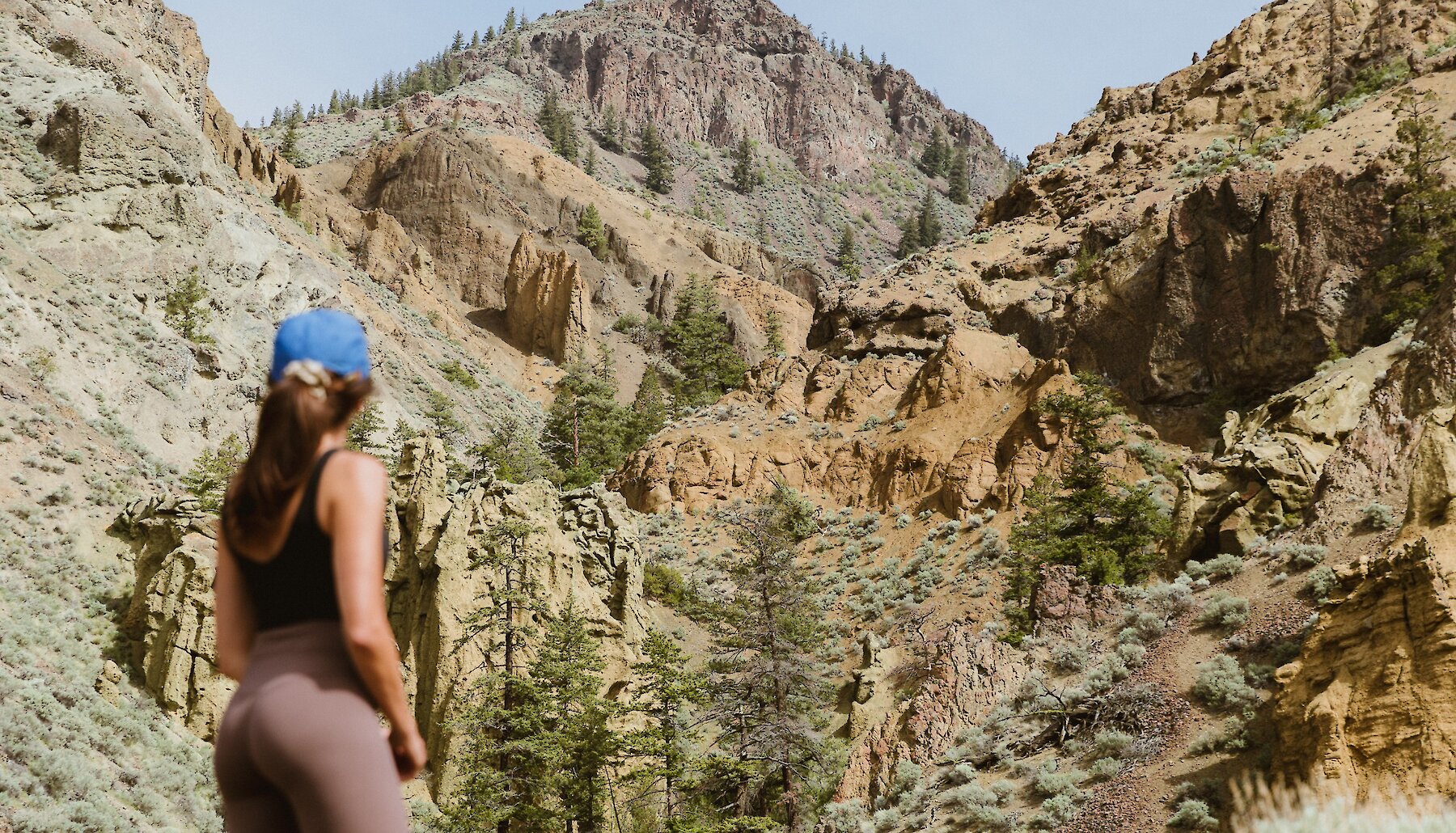 A hiker approaches the Cinnamon Ridge hoodoos, via a trail accessible off Ord Road in Kamloops BC.