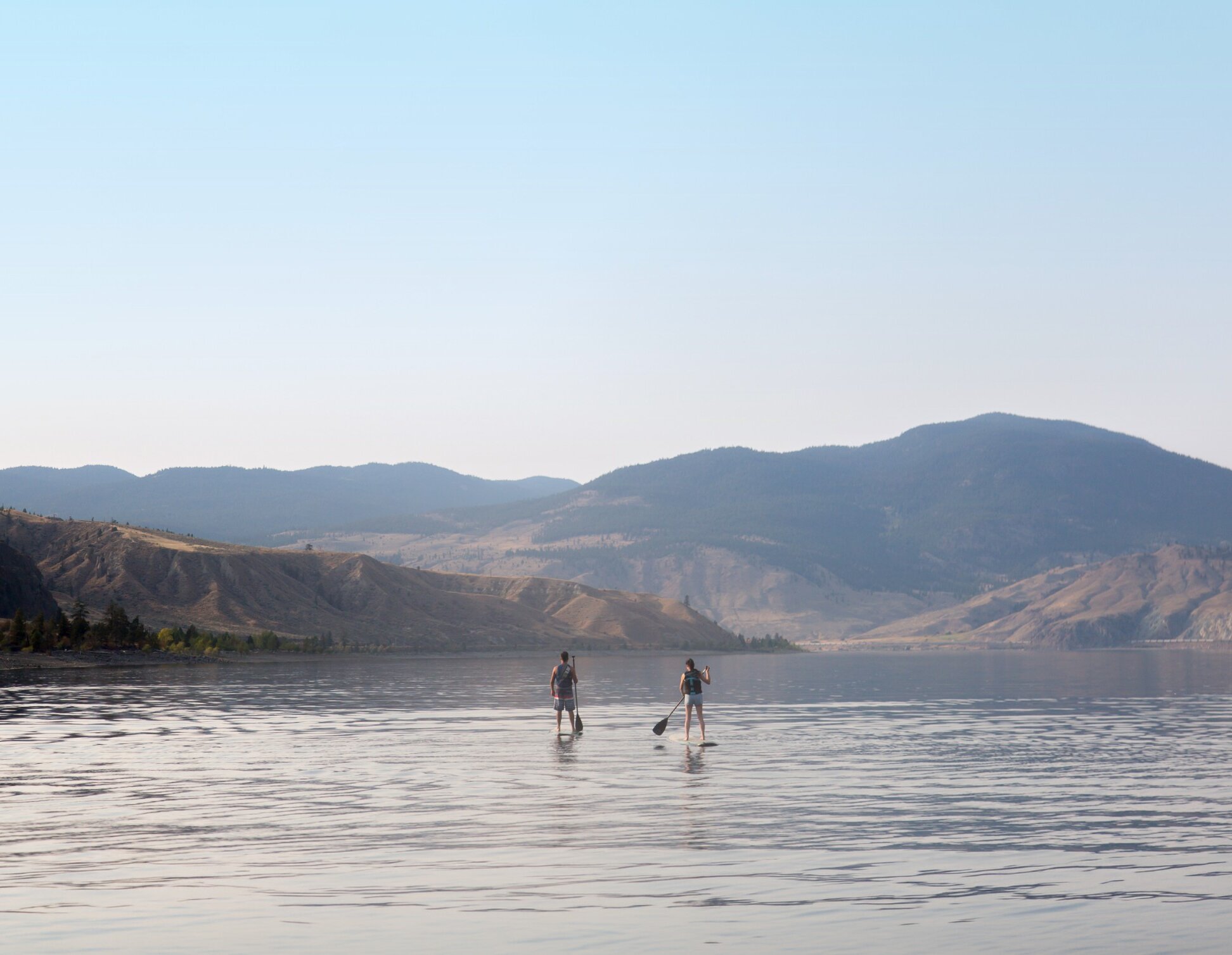 2 people paddleboarding on Kamloops Lake