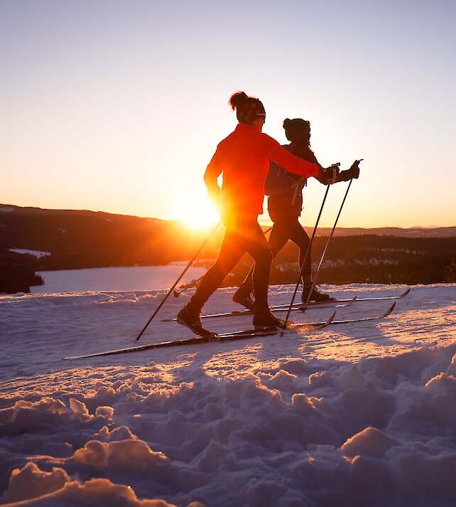 A couple cross-country skiing at dusk in Kamloops, BC.