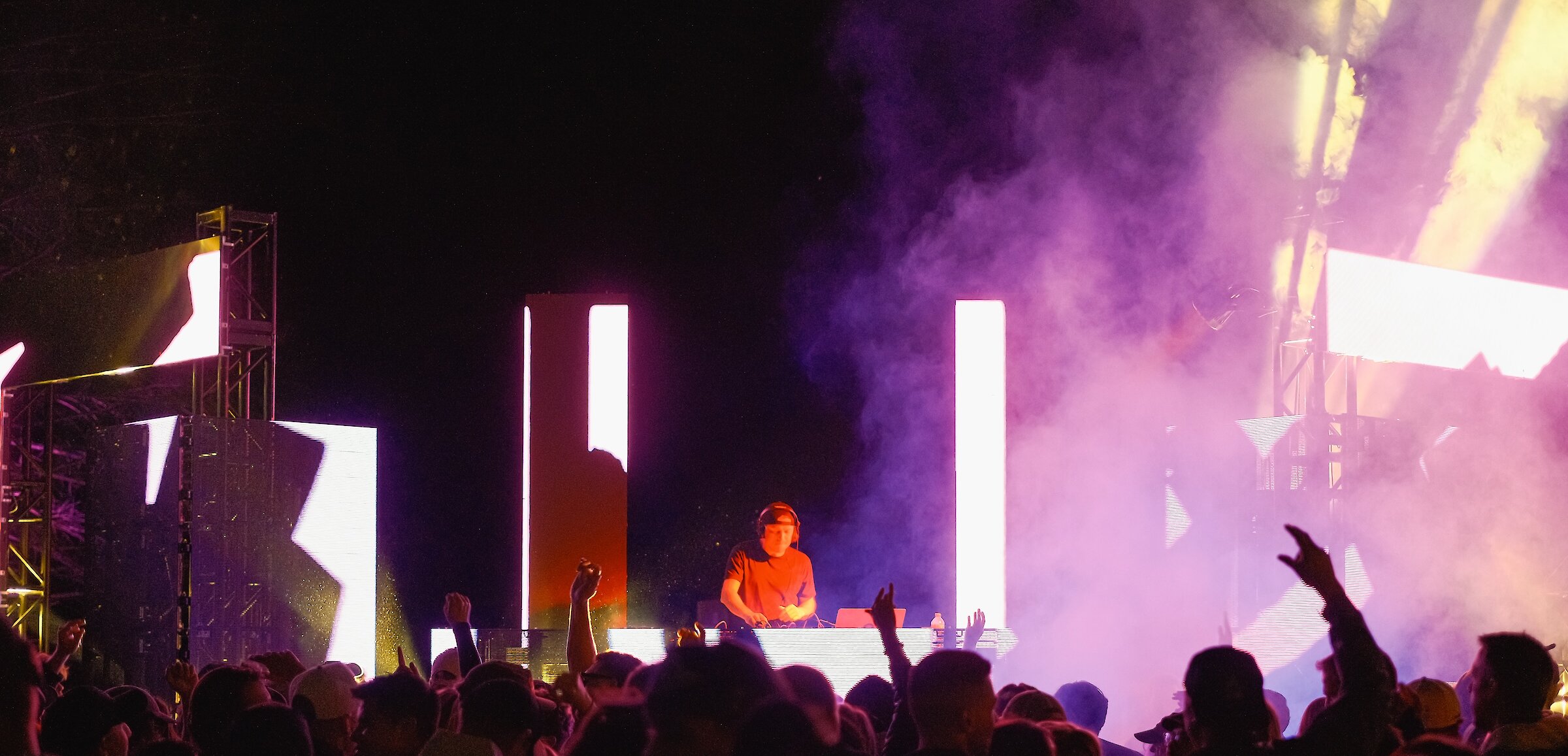 DJ surrounded by lights playing in front of a crowd at BrewLoops Craft Beverage & Music Festival in Kamloops, BC.
