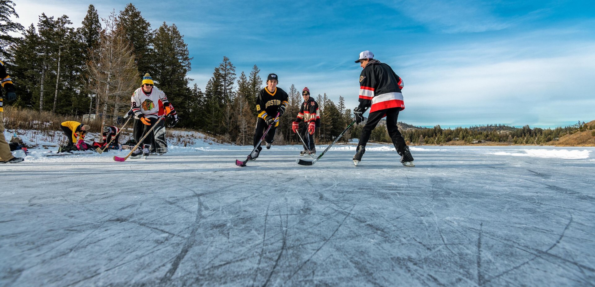 A friendly outdoor hockey game taking place on Inks Lake in Kamloops, BC.