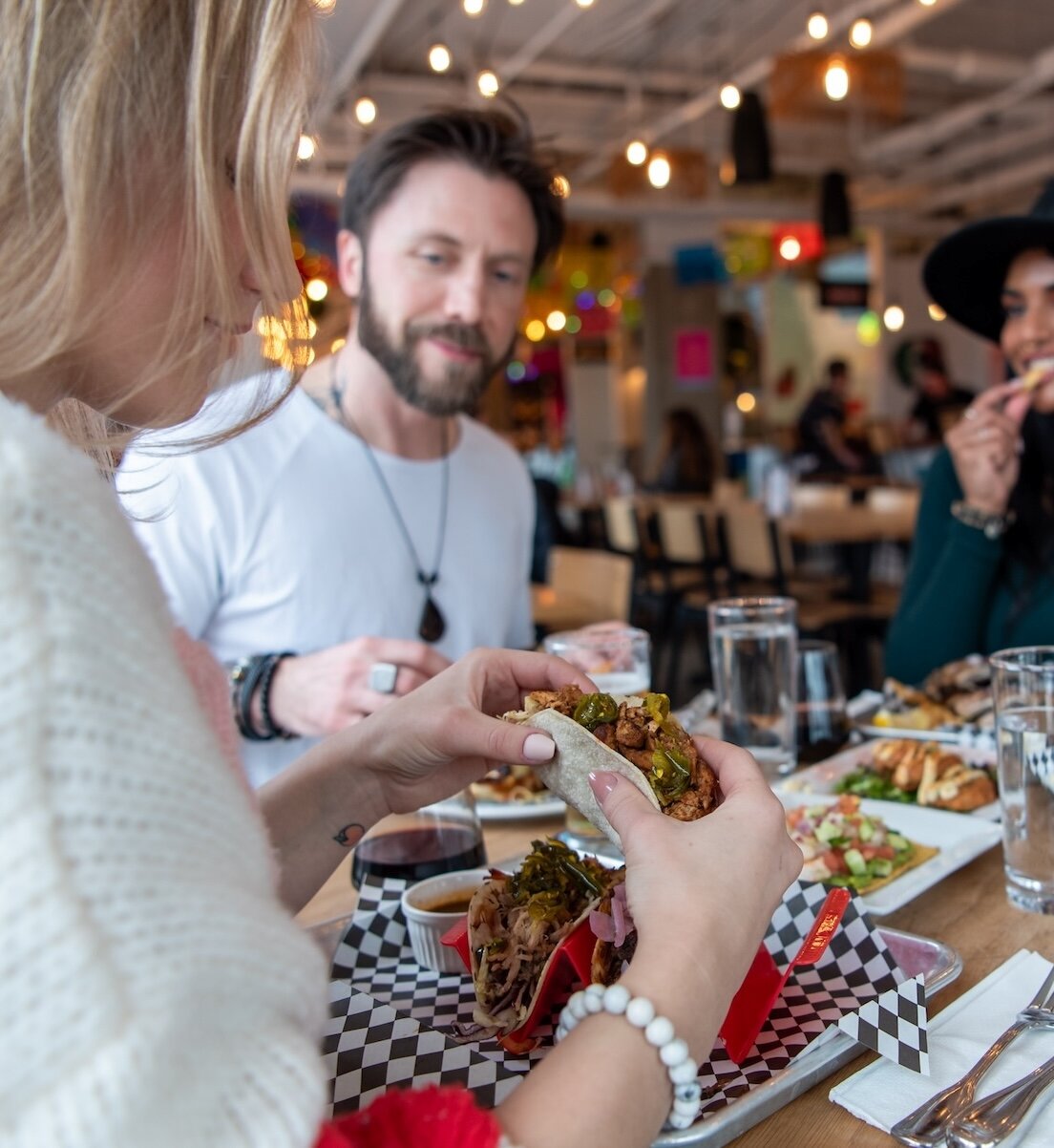 A group of friends eating at Yew Street Food Hall on the North Shore in Kamloops, BC.