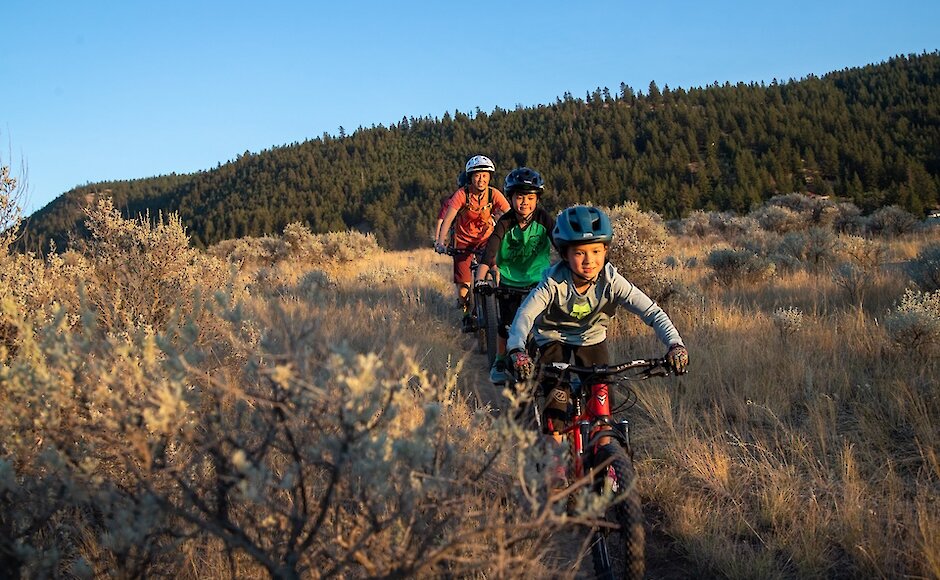 Family laughing while taking a break from mountain biking at the Kamloops Bike Ranch in British Columbia.