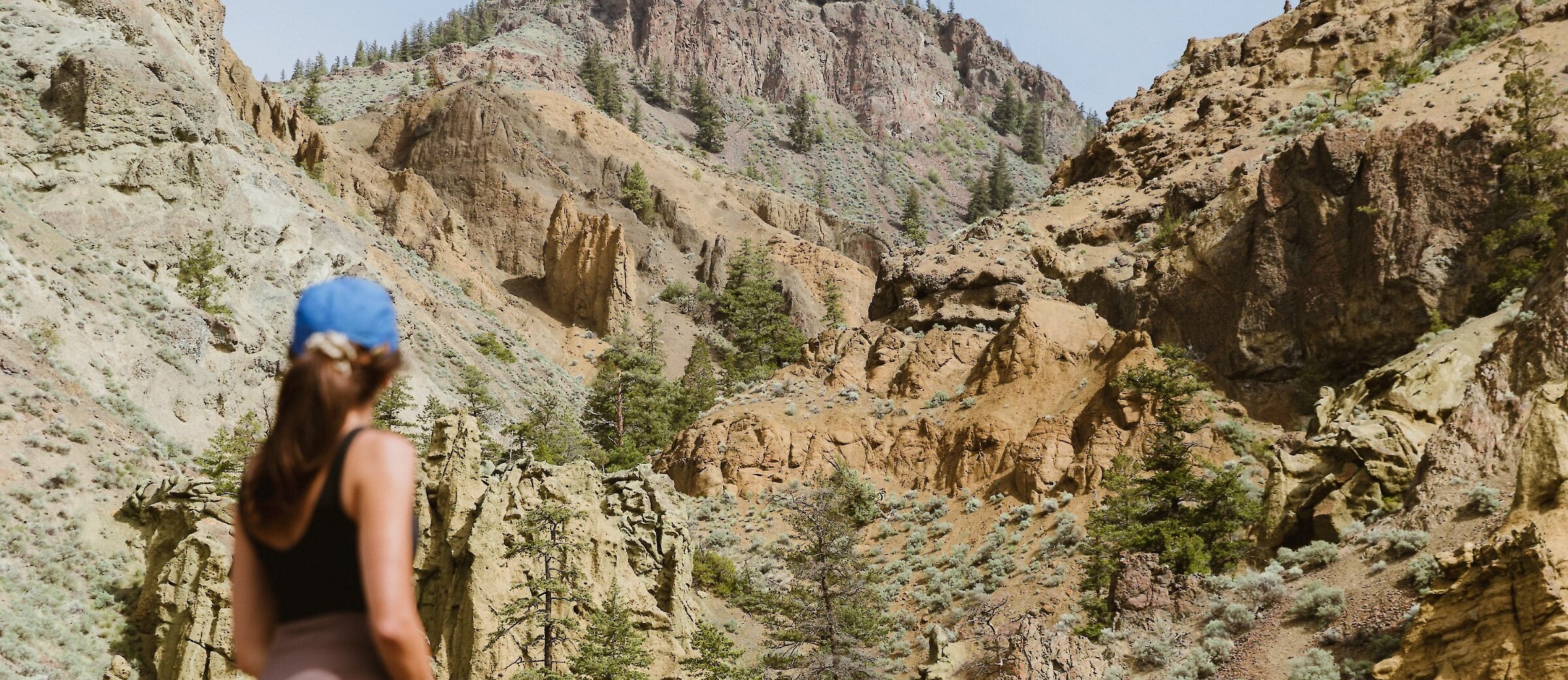 A hiker admiring the Cinnamon Ridge Hoodoos in Kamloops, BC.