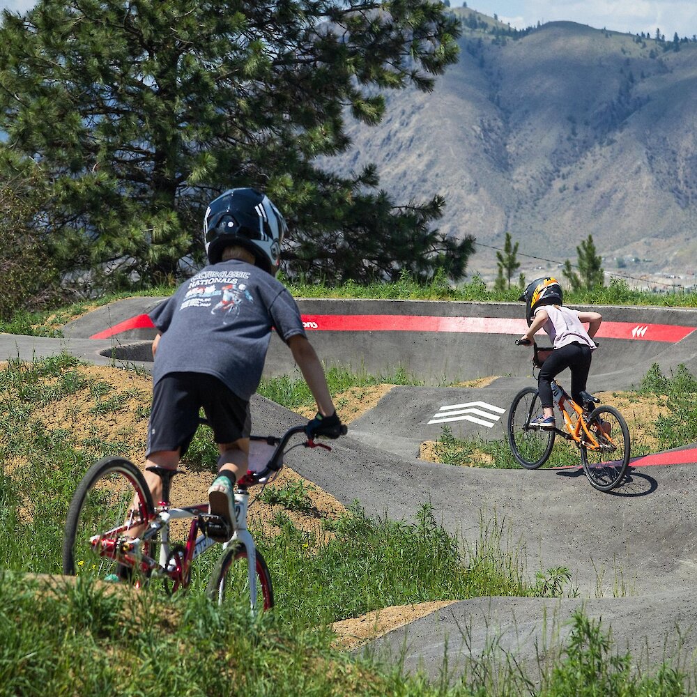Children ride the All-wheels pump track in Kamloops BC