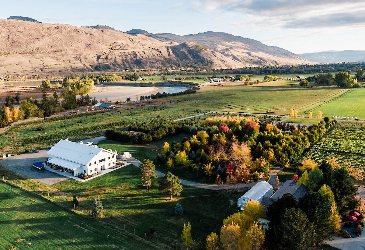 Privato Vineyard and Winery located in Kamloops BC, as seen from above with the mountains in the background with the surrounding vineyards.