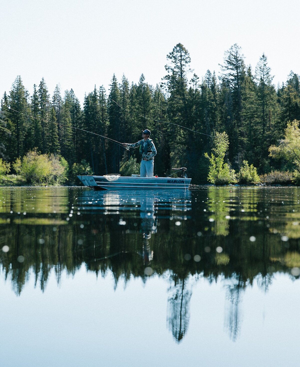 man fly flishing on boat.