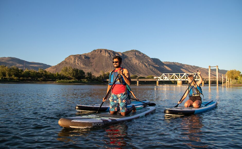 two people paddle boarding