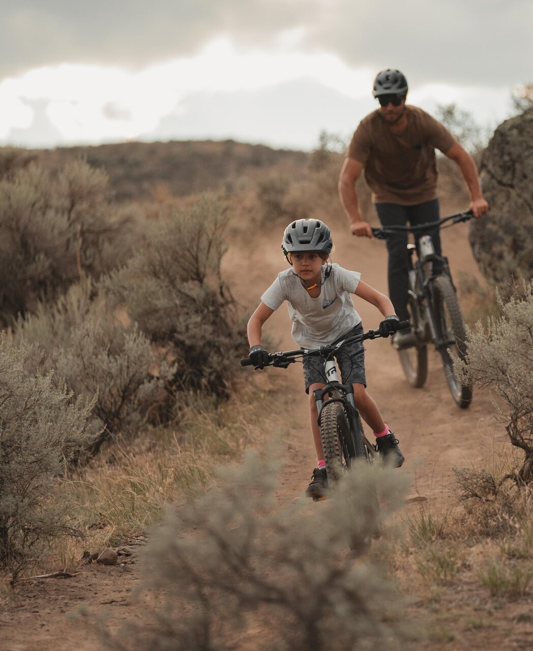 A father and son on a run bike mountain biking in Kamloops, BC