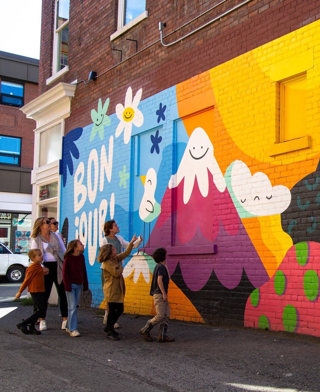A group of visitors admiring the Back Alley Art mural in downtown Kamloops.