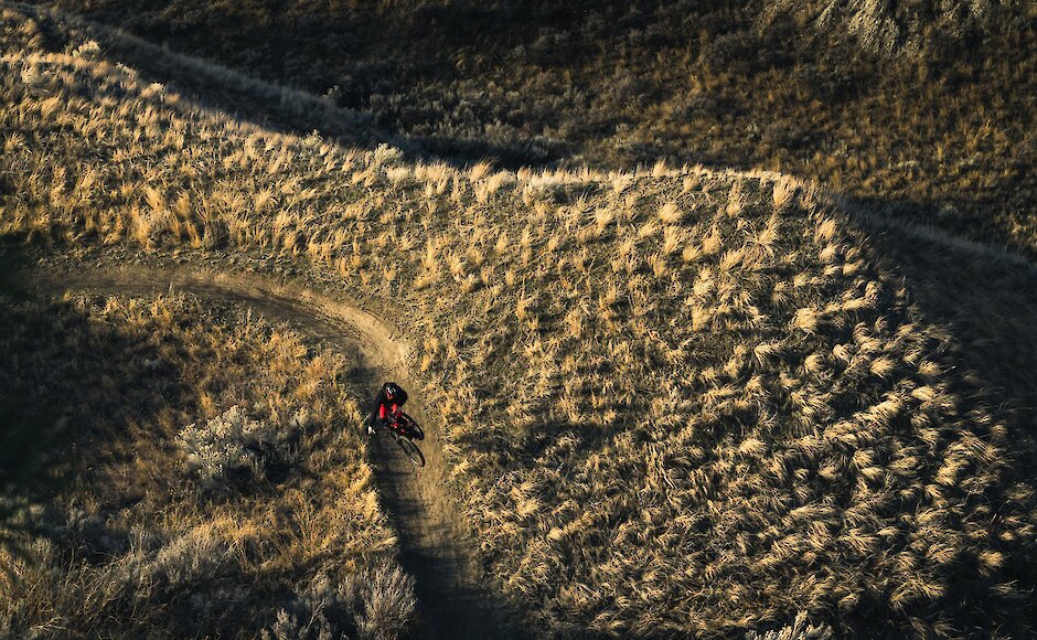A mountain biker rides through the grassland trail at the Kamloops Bike Ranch.
