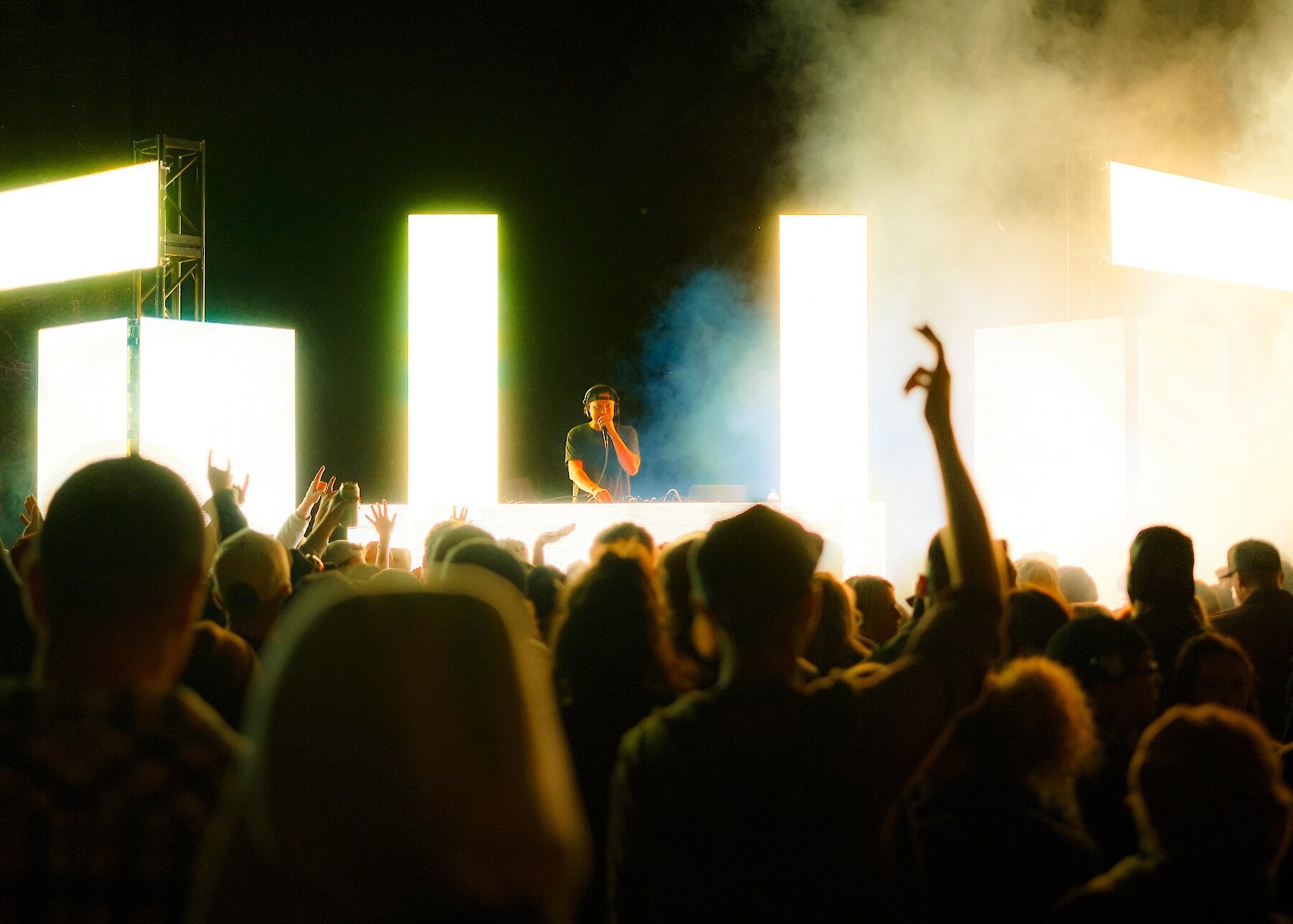 A DJ playing on stage surrounded by lights at the Brewloops Festival in Kamloops, BC.
