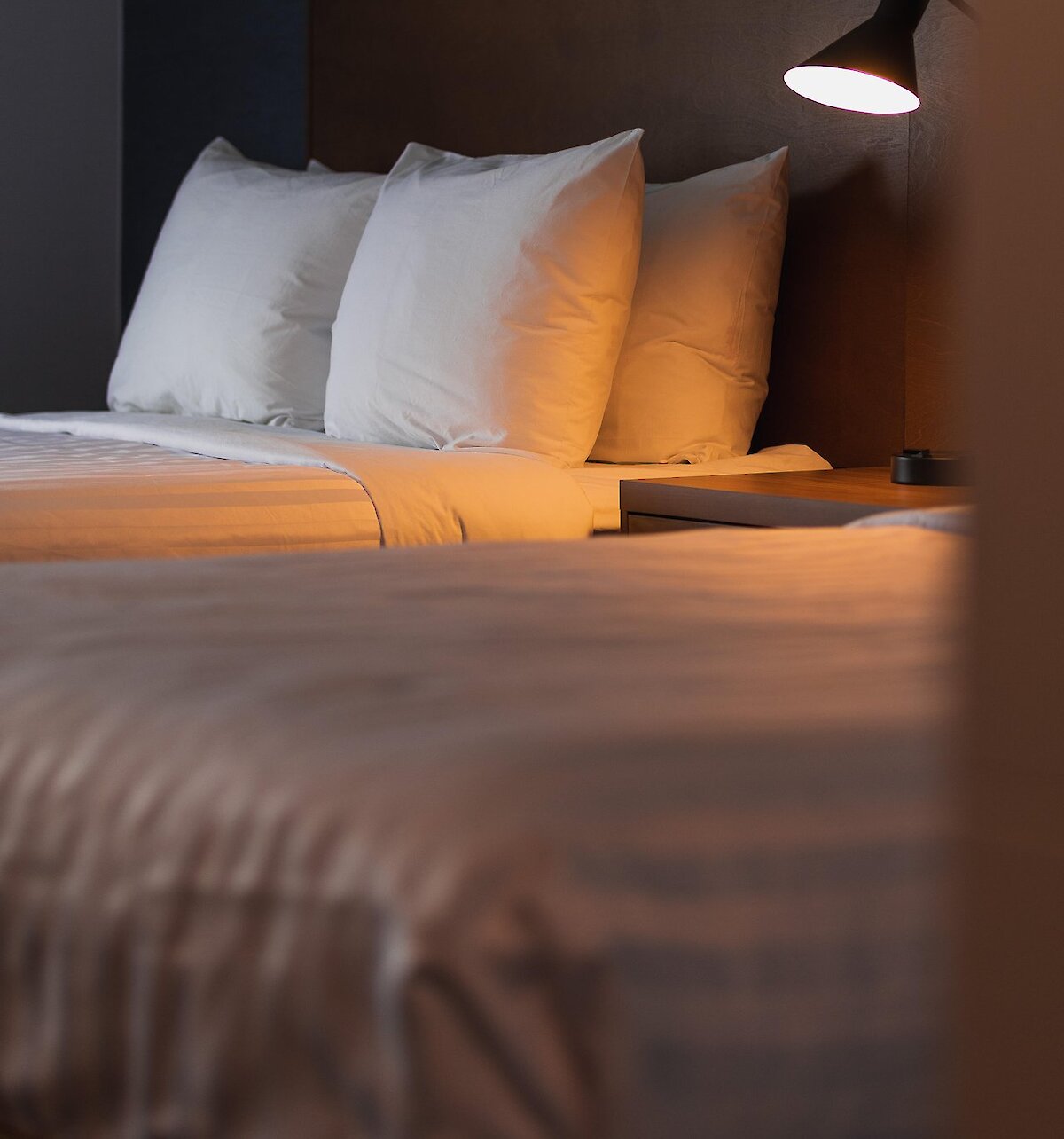 A neatly made hotel bed at the Prestige Kamloops Hotel.
