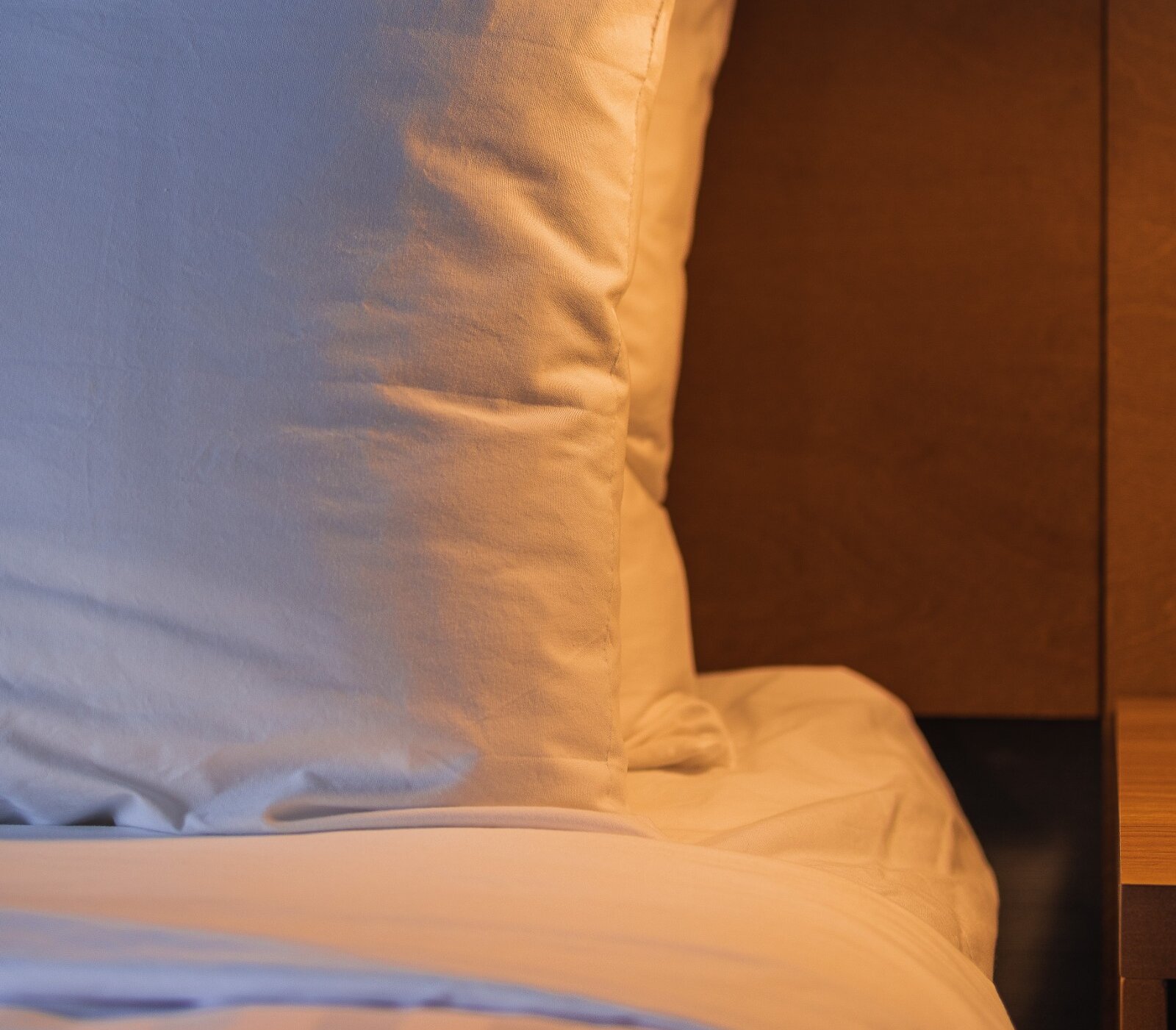 A neatly made hotel bed at the Prestige Kamloops Hotel.