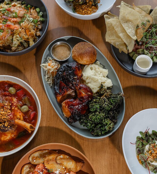 A couple cheers their wine glasses dining at Isagani Farm-to-Table in Kamloops, BC.
