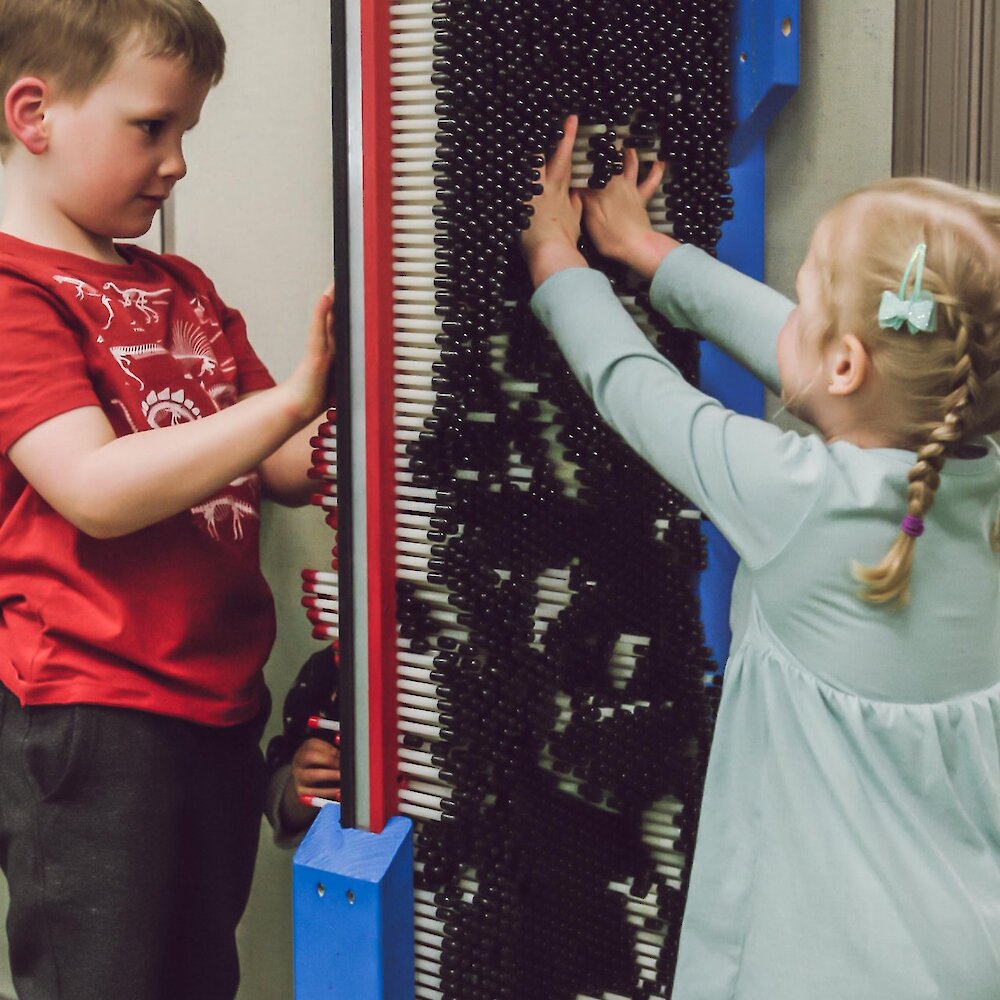Two children playing with the interactive exhibit at the BIG Little Science Centre in downtown Kamloops, BC.