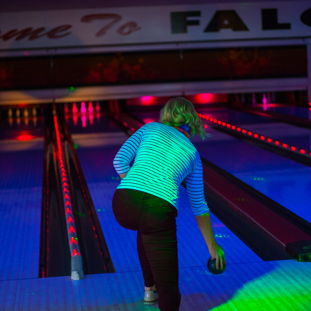 A women throwing her bowling ball down the lane during laser bowling at Falcon Lanes Bowling in Kamloops, BC.