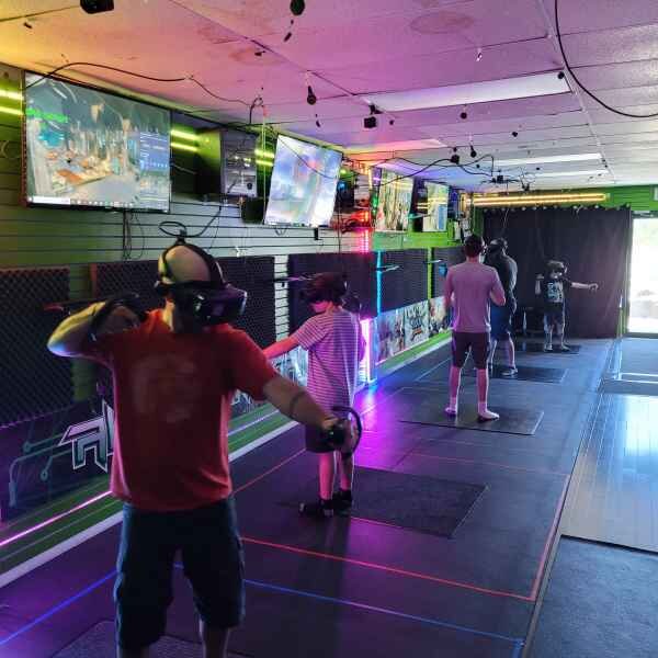 Gamers wearing headsets and playing in virtual reality at All Around GamerZ in Kamloops, BC.