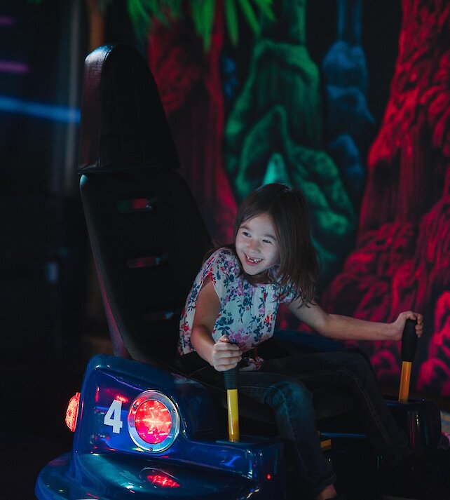 A young girl enjoying the bumper cars at Fun Factor Fun Centre in Kamloops, BC.