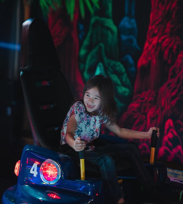 A young girl enjoying the bumper cars at Fun Factor Fun Centre in Kamloops, BC.