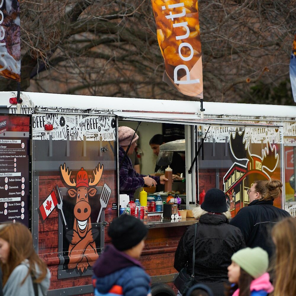 Market-goers line up at the Moose Caboose Food Truck for poutine and burgers at the Kamloops Christmas Market.