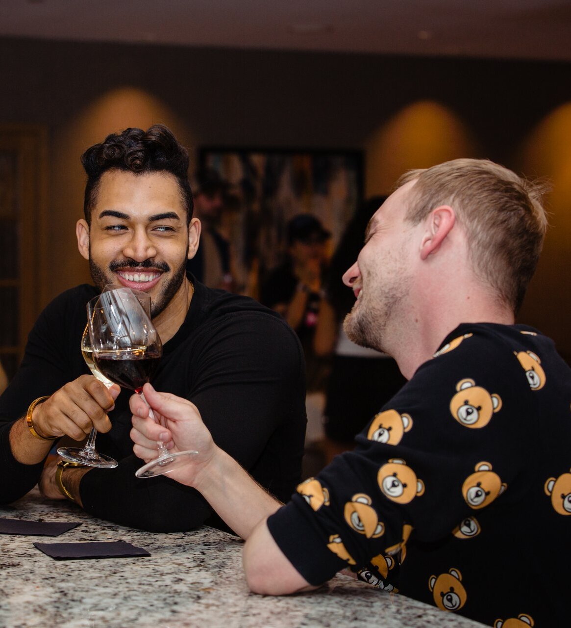 Two men cheers their wine at Cordo Resto & Bar located in downtown Kamloops, BC.